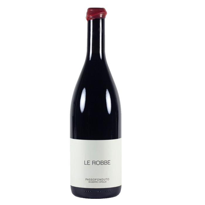 Red wine bottle with burgundy glass and white label reading LE ROBBE