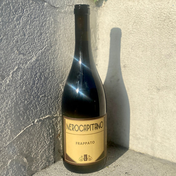Dark wine bottle with NERO CAPITANO & FRAPPATO label and black cap.