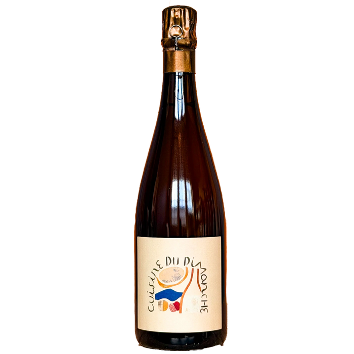 Champagne bottle with gold foil crown and amber glass, colorful label on front