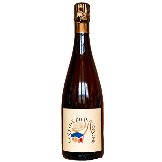 Champagne bottle with gold foil crown and amber glass, colorful label on front