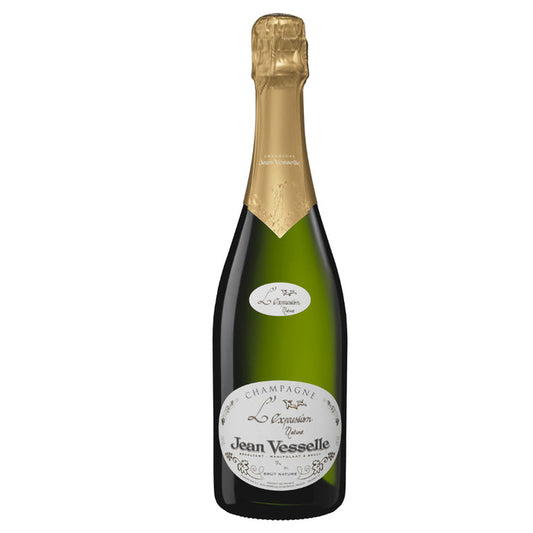 Champagne bottle with gold foil top and green glass, front label visible