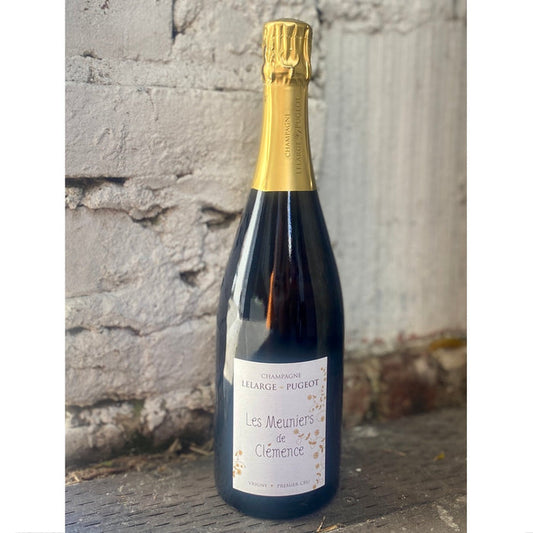 Champagne bottle with gold foil cap and blue glass, front label visible